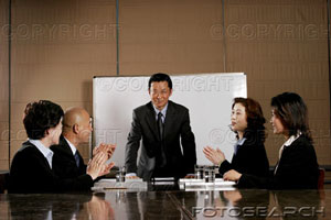 Business man and women clapping their hands after a good presentation.jpg